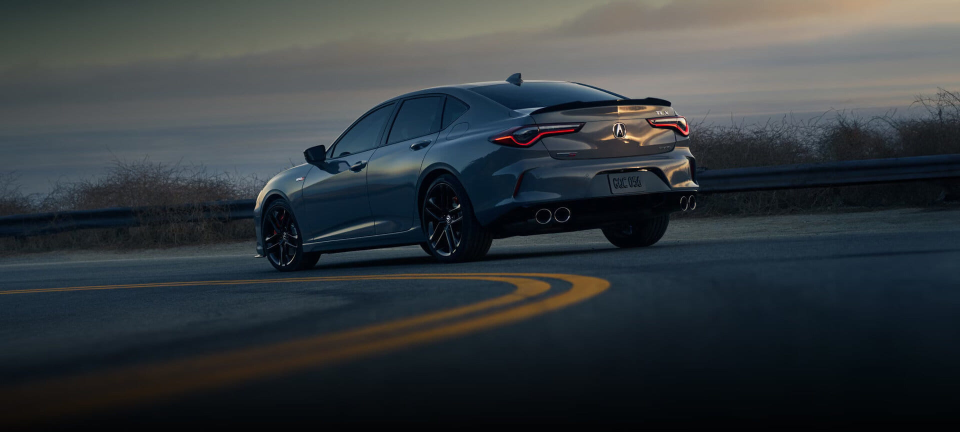 A 2025 Acura TLX Type S in motion, showcasing its dynamic performance and aggressive styling.