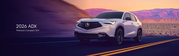 2026 ADX Premium Compact SUV on a scenic desert road at sunset. The sleek, modern design is emphasized against purple and orange sky hues.
