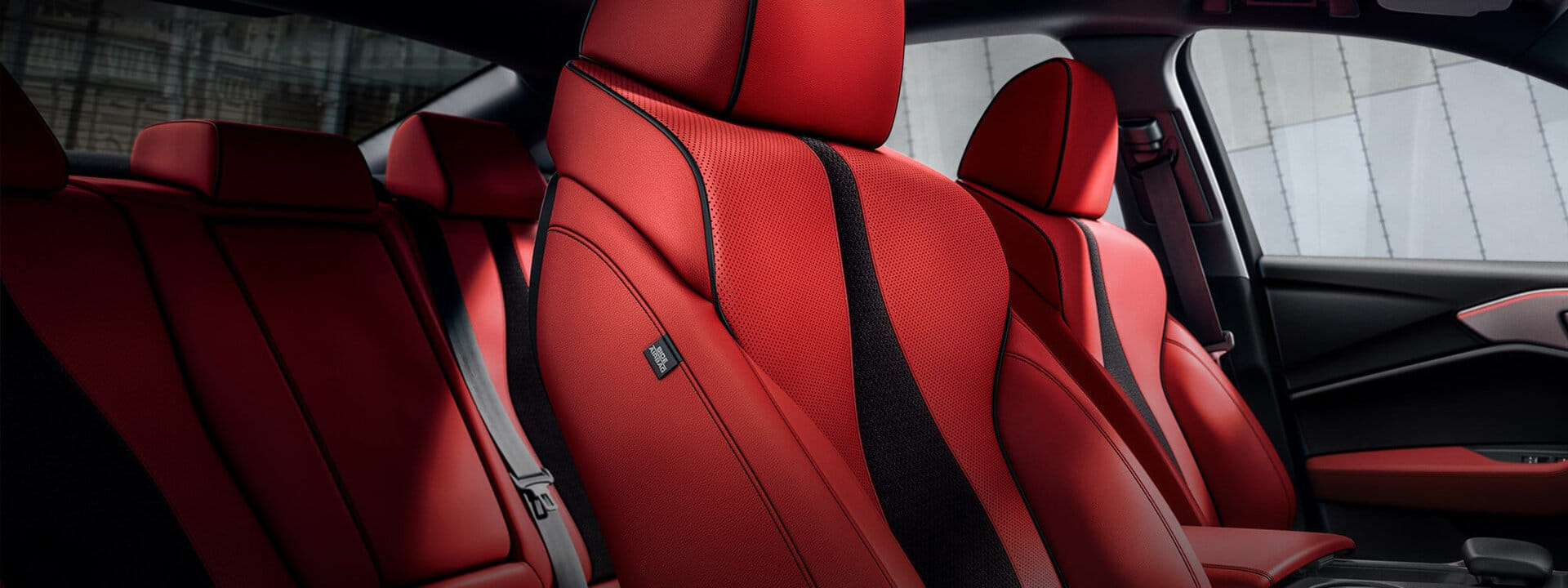 Interior view of a 2025 Acura TLX, highlighting the premium leather sport seats and advanced dashboard.