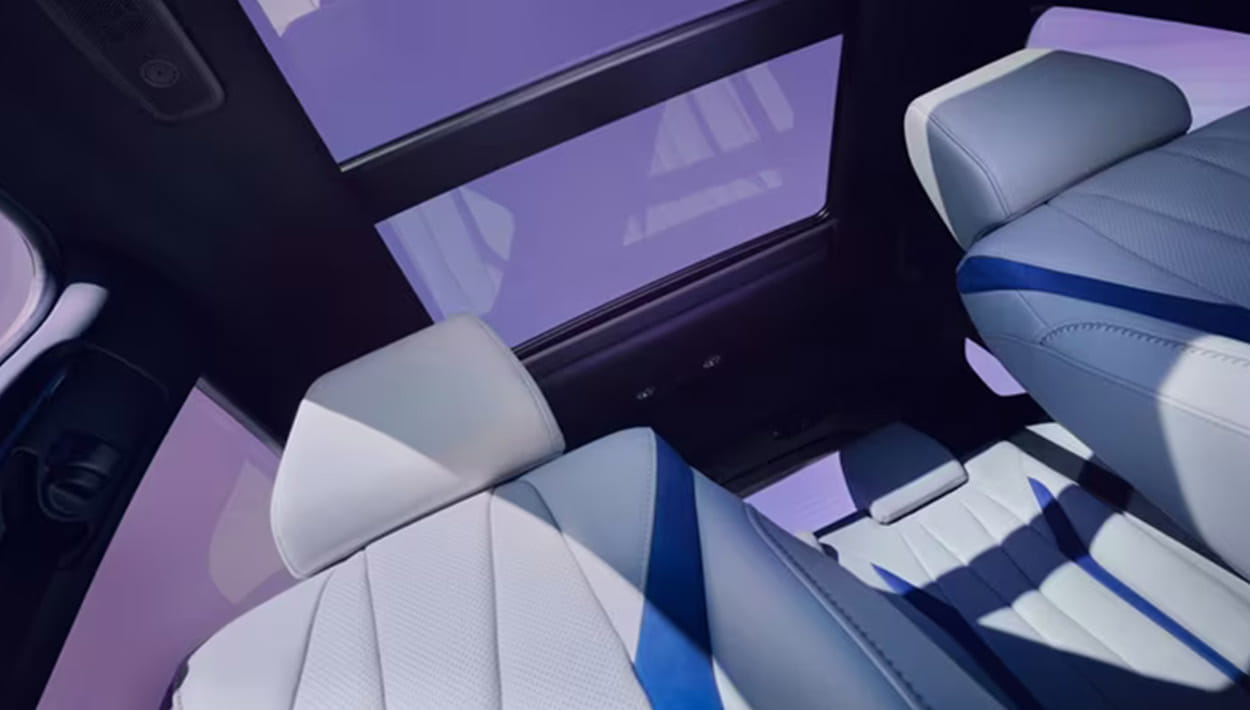 Interior view of a car featuring blue and white seats, showcasing a modern and stylish design.