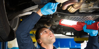 Mechanic Inspecting Vehicle