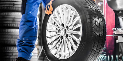 Mechanic holding tire