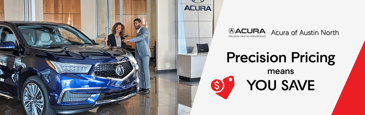 Man shows woman car in car showroom acury