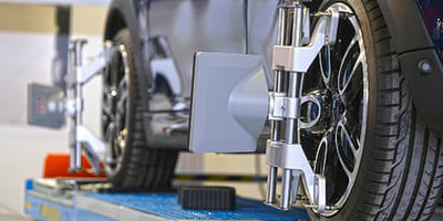 Mechanic working on wheel alignment