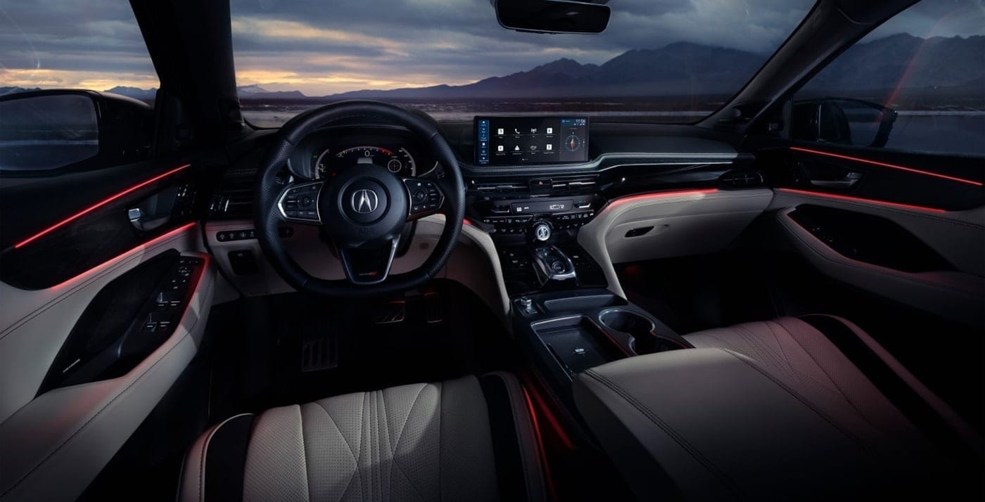 Sleek 2026 Acura MDX interior with modern design, featuring a stylish steering wheel, glowing ambient lighting, and a high-tech dashboard display.