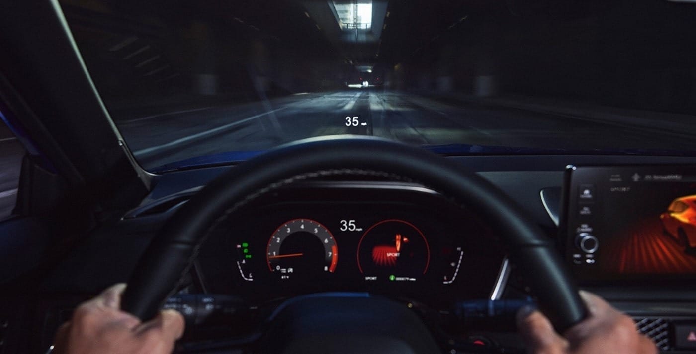 View from a driver's perspective inside 2026 Acura Integra, displaying speed and performance metrics on a digital heads-up display.