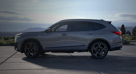 A gray 2026 MDX, shown from the driver’s side, with mountains in the background.