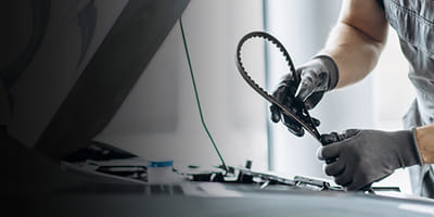 Mechanic working on timing belt service