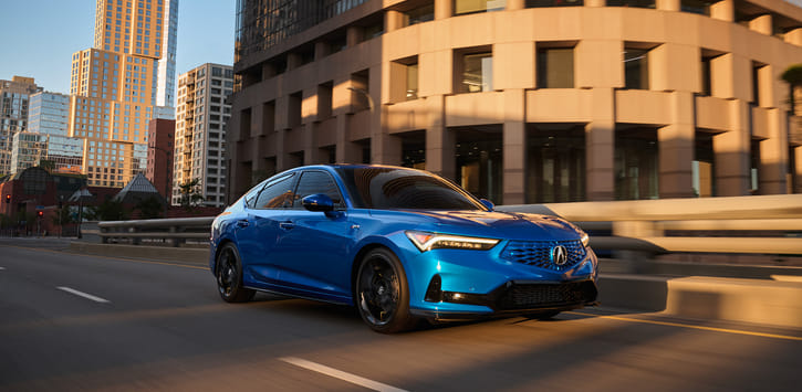 A blue 2026 Integra driving through the city.