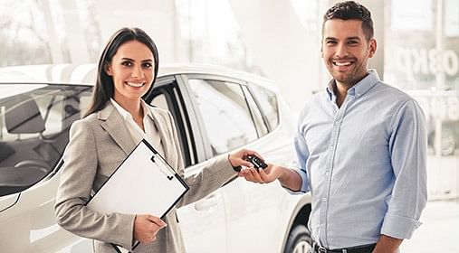 Smiling woman receives car keys