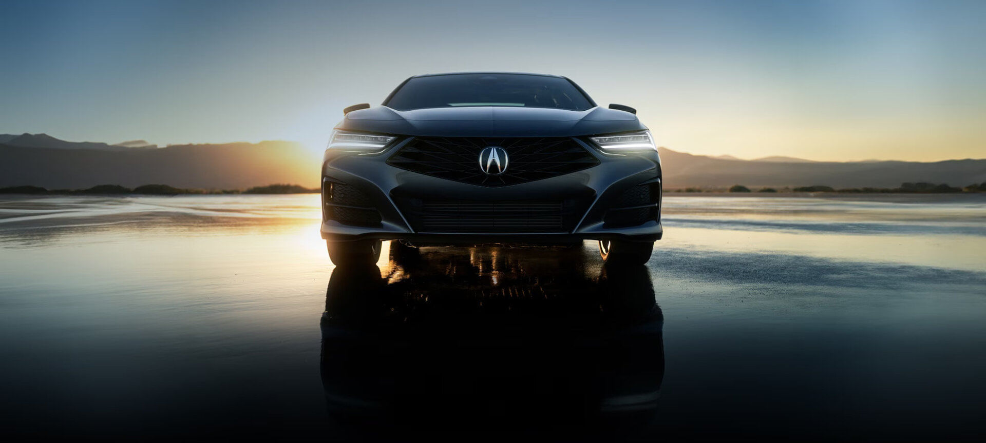 Exterior detail of a 2025 Acura TLX, showcasing its Jewel Eye® LED headlights and dynamic front grille.