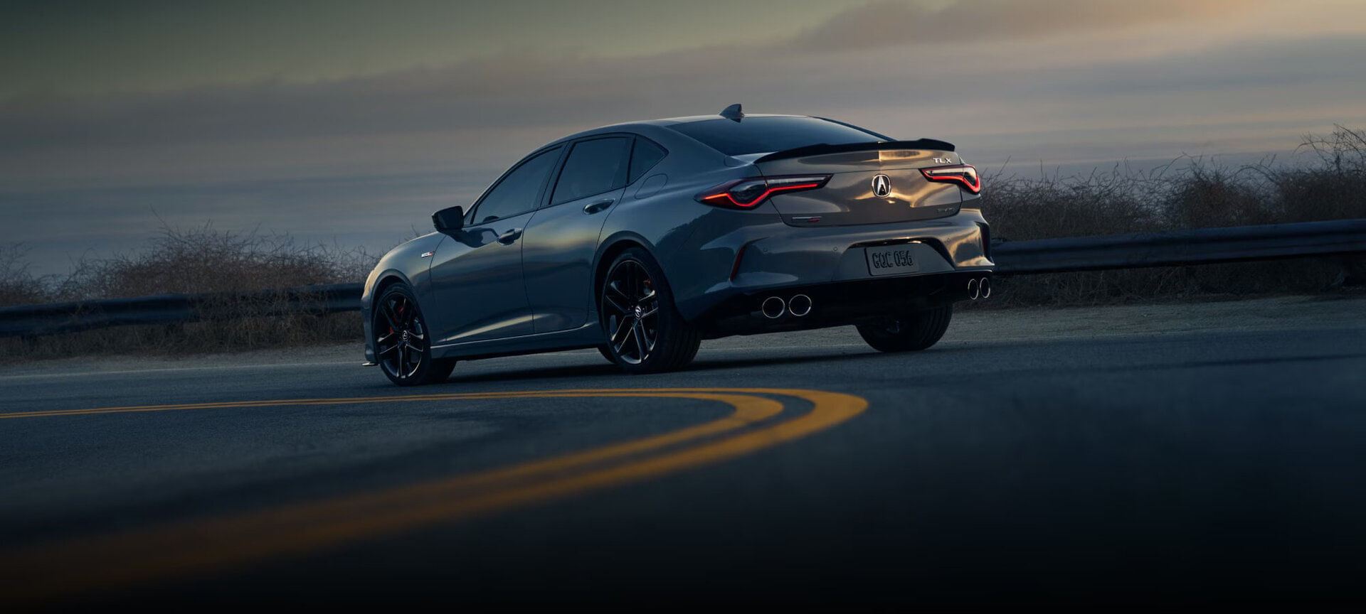 A 2025 Acura TLX Type S in motion, showcasing its dynamic performance and aggressive styling.