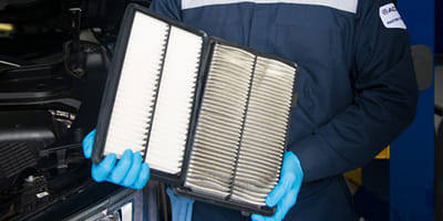 Mechanic holding a filter