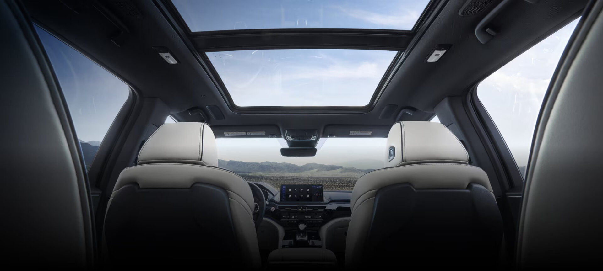Interior view of a 2025 Acura MDX, highlighting premium leather seating, panoramic moonroof, and spacious cabin.