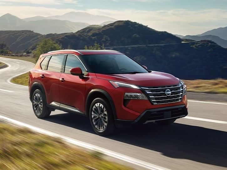 The 2026 Nissan Rogue navigates a scenic mountain road, showcasing its rugged design and adventurous spirit.