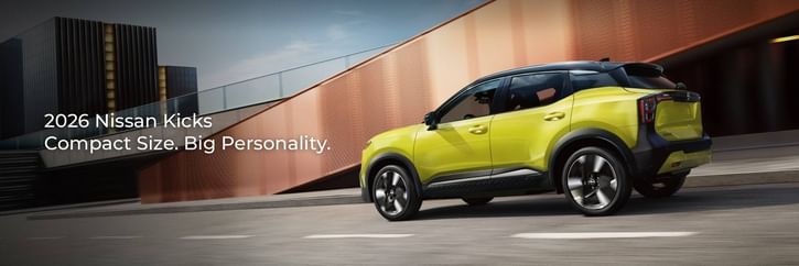 A vibrant yellow 2026 Nissan Kicks drives along a modern urban road, featuring sleek lines and a dynamic design against a stylish backdrop.