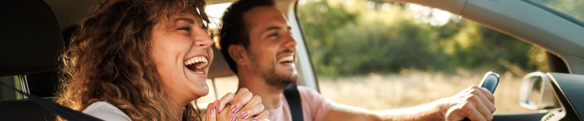 Couple driving a vehicle happily