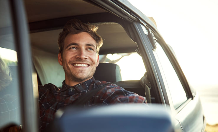 Man staring out of the vehicle he just purchased