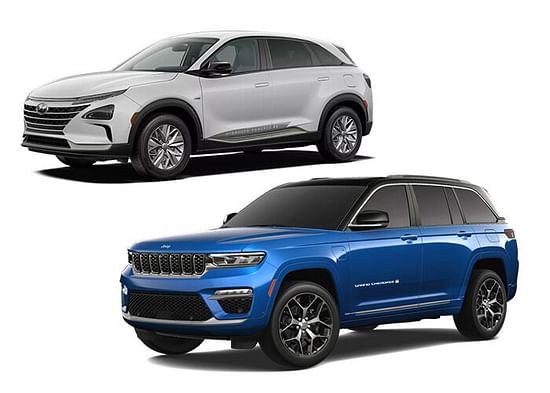 A blue Jeep Grand Cherokee with a white Hyundai Nexo on a white background.