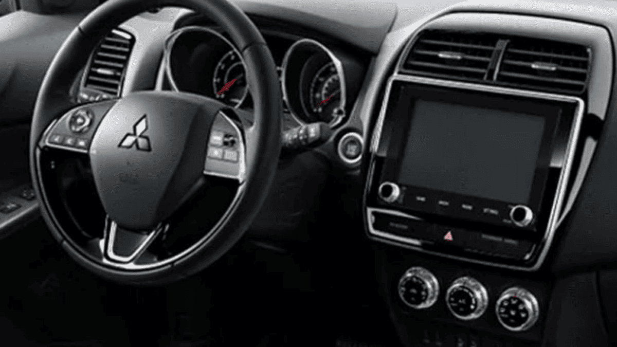 Interior cockpit view of the 2024 Mitsubishi Outlander Sport Trims near Tampa, FL, showing the steering wheel, gauge cluster, and center controls.