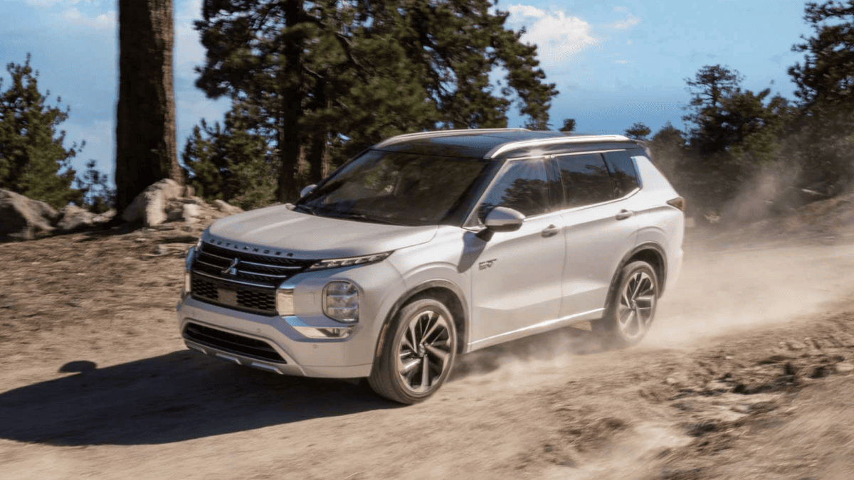 The 2025 Mitsubishi Outlander PHEV parked near a forest trail outside Tampa, FL, emphasizing eco-conscious SUV capabilities and rugged design.