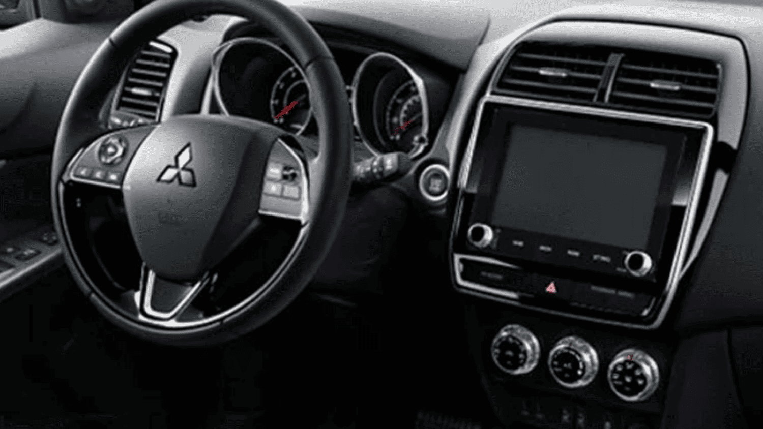 Steering wheel and center console of the 2025 Mitsubishi Outlander Sport near Lakeland, FL, designed for comfort & control.
