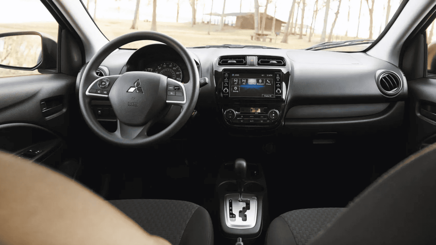 Dashboard and front interior of the 2024 Mitsubishi Mirage G4 showing user-friendly controls and infotainment system in Lakeland, FL.