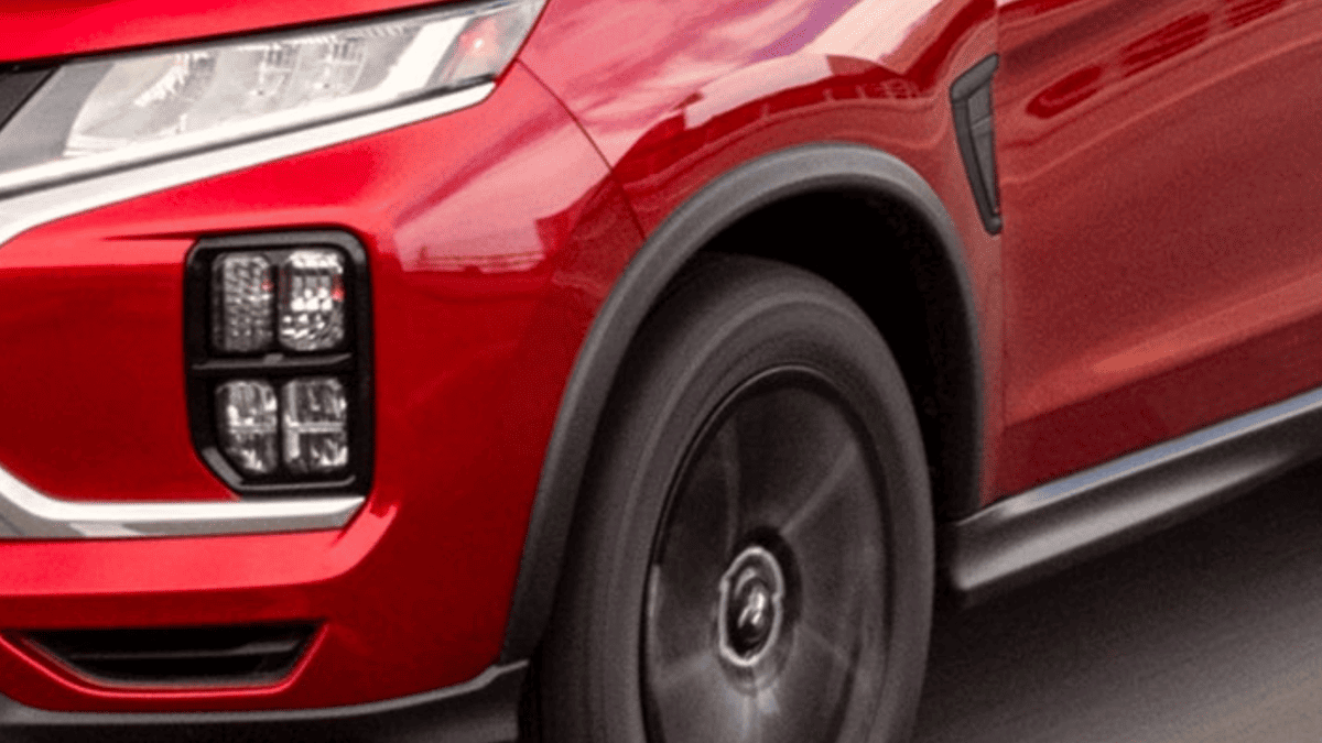Close-up of the 2024 Mitsubishi Outlander Sport’s front wheel and LED headlights, highlighting sharp details near Tampa, FL