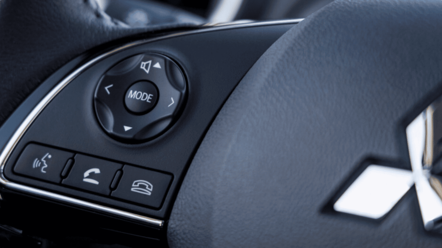 Close-up of the 2024 Mitsubishi Mirage G4 steering wheel controls near Lakeland, FL, showing integrated phone and audio buttons.