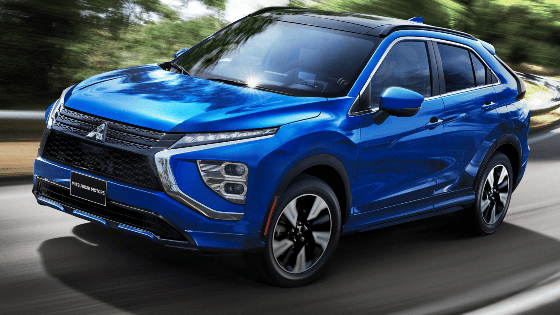 2025 Eclipse Cross in motion on road with dynamic front grille and LED lights