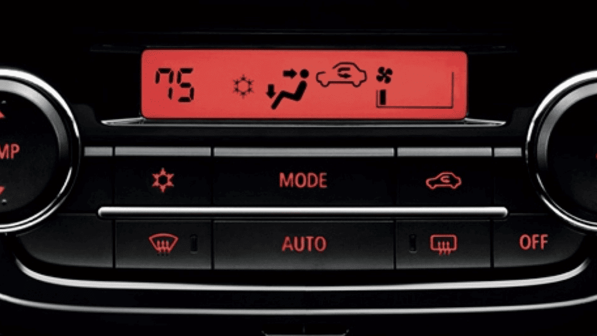 Close-up of the 2024 Mitsubishi Mirage climate control panel, with red digital display and labeled buttons, highlighting the model's user-friendly AC and defrost system.