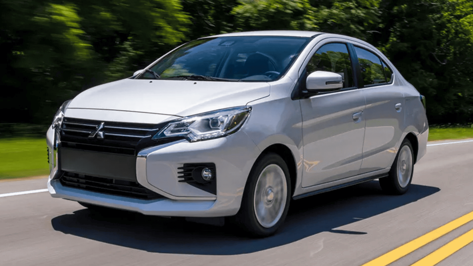 2024 Mitsubishi Mirage G4 sedan driving on a scenic road in Brandon, FL