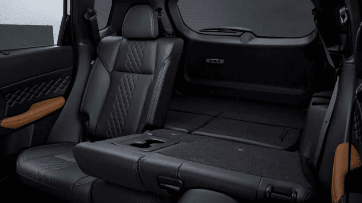 Interior of the 2024 Mitsubishi Outlander near Tampa, FL with quilted leather seats and folded third row for added cargo space.