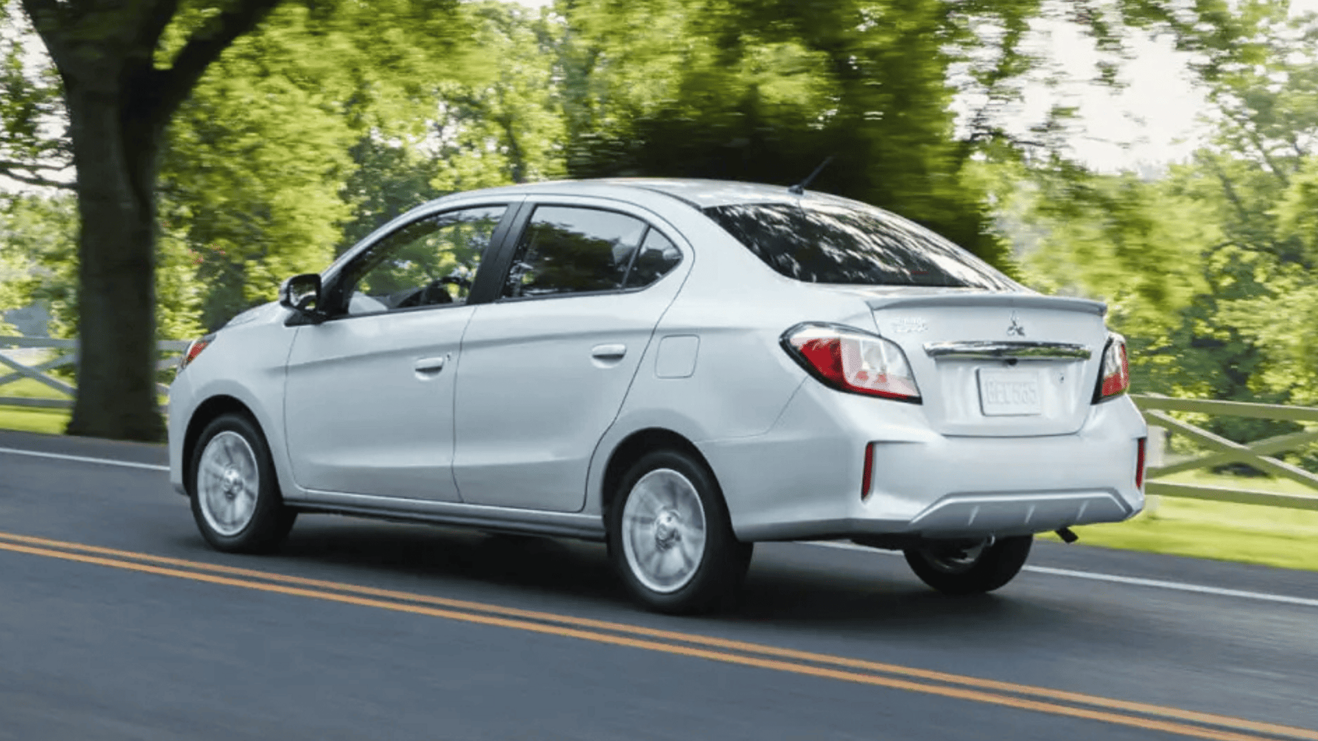Rear view of 2024 Mitsubishi Mirage G4 driving on suburban road in Brandon, FL