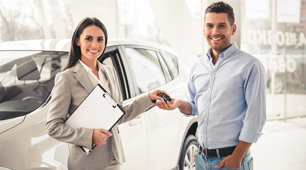 Happy man receiving car keys photo