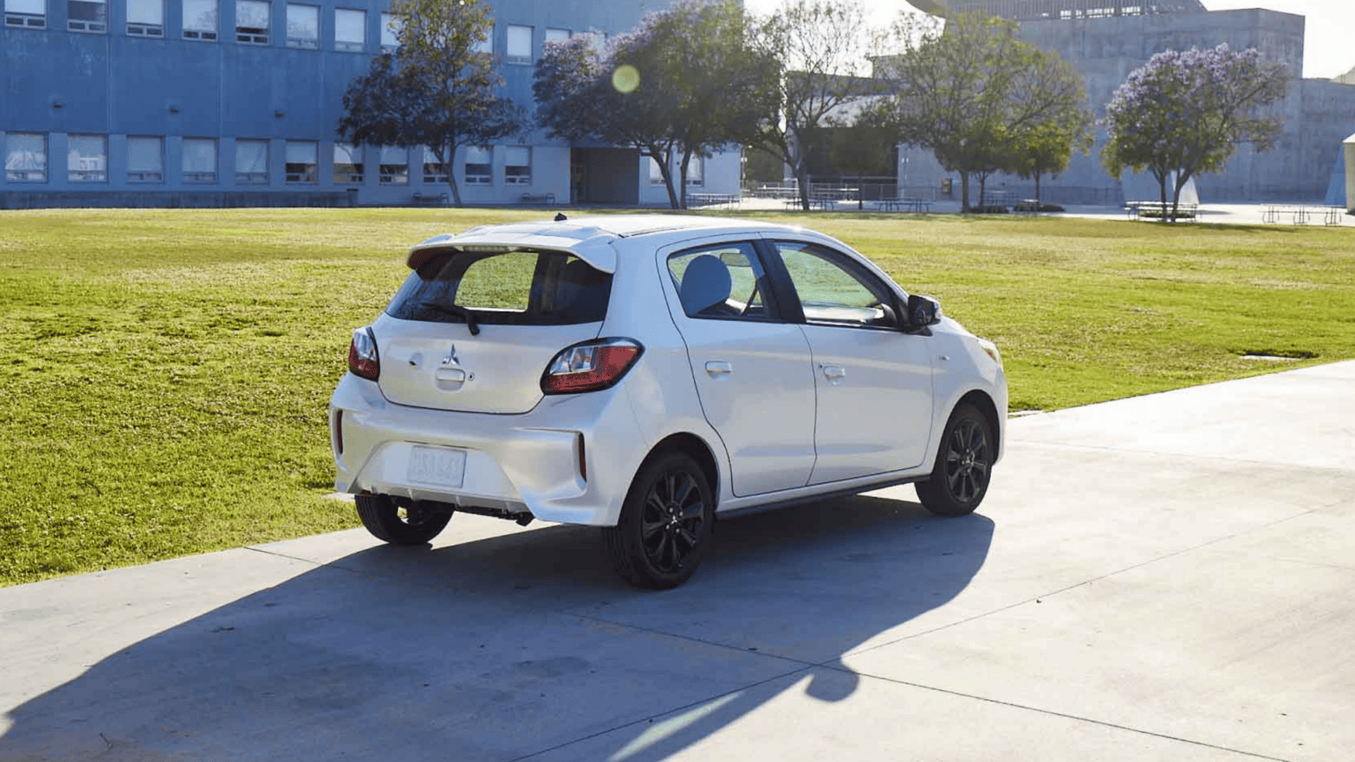 Rear angle of 2024 Mitsubishi Mirage hatchback parked by a grassy field in Brandon, FL