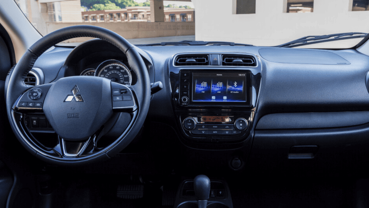 Front cabin of the 2024 Mitsubishi Mirage G4, displaying the infotainment system, climate controls, and the steering wheel with integrated functions—ideal for tech-savvy urban drivers.