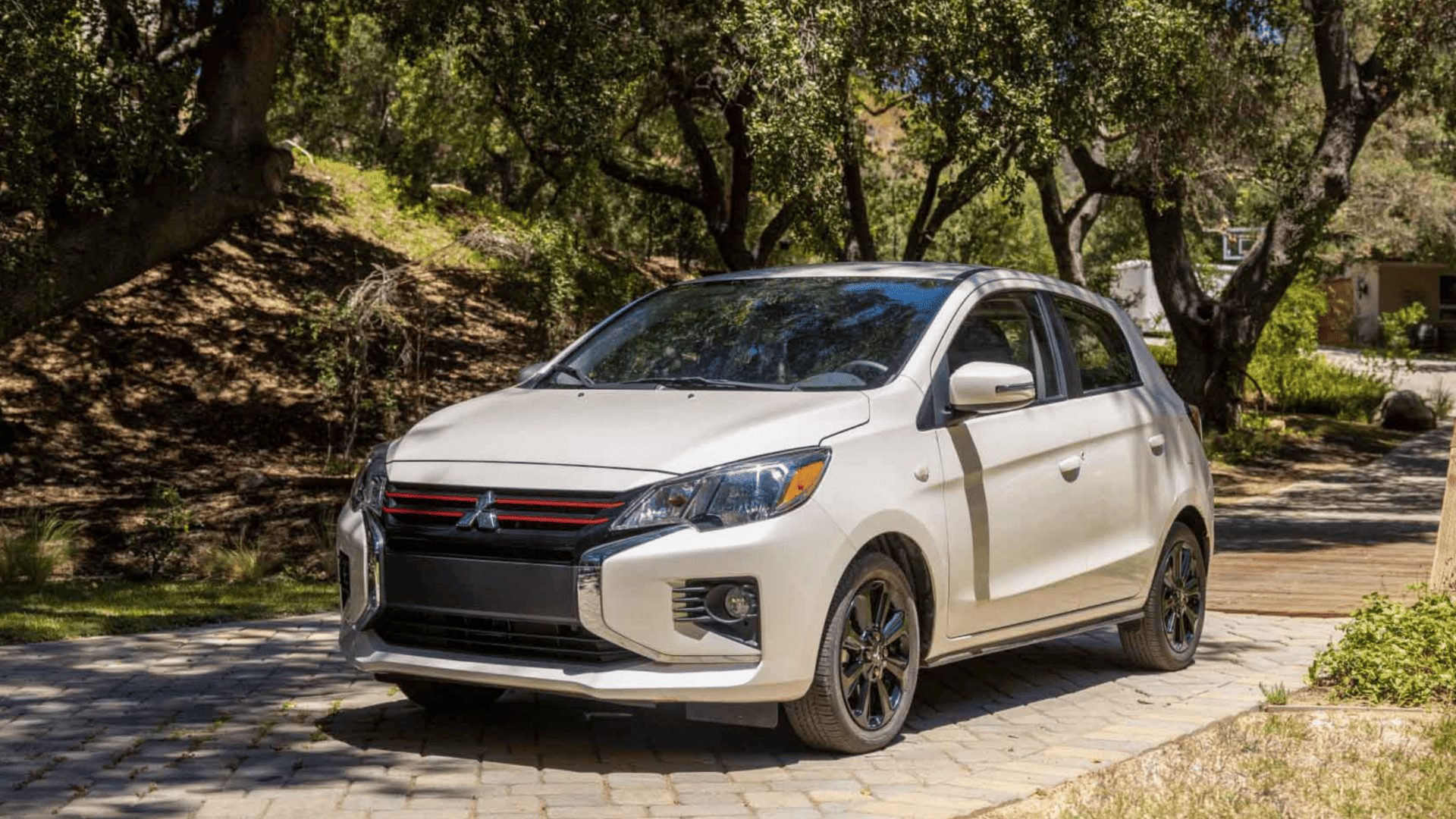 Front view of 2024 Mitsubishi Mirage hatchback in white parked outdoors in Brandon, FL