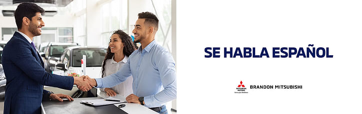 Salesperson happily assist a customers standing in a car dealership on the left side. Black text "SE HABLA ESPAÑOL" and Clemons Mitsubishi logo on the right side.