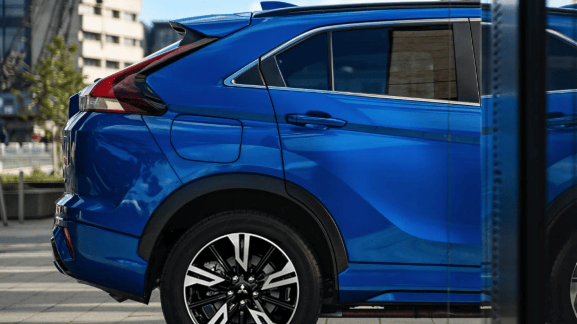 2025 Mitsubishi Eclipse Cross rear-side view in blue with black roof accents