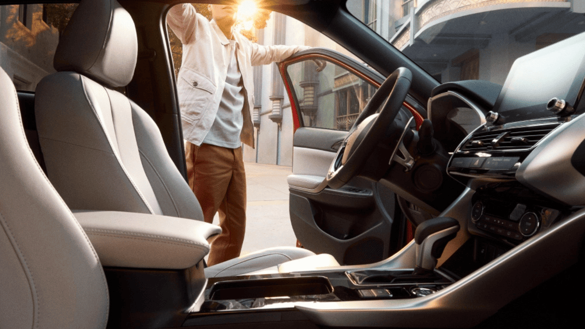 Interior shot of the 2025 Mitsubishi Eclipse Cross near Tampa, FL, showing the driver-side cabin with sleek silver trim and leather seating.