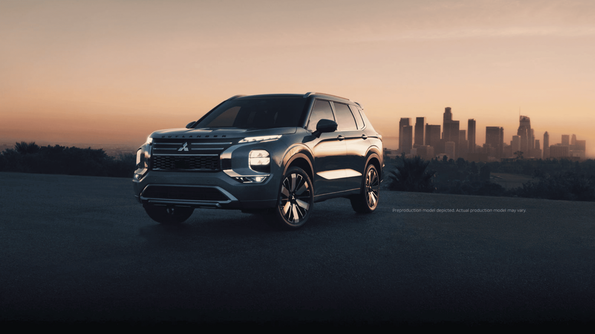 2025 Mitsubishi Outlander SUV parked at sunset with city skyline in background near Brandon, FL