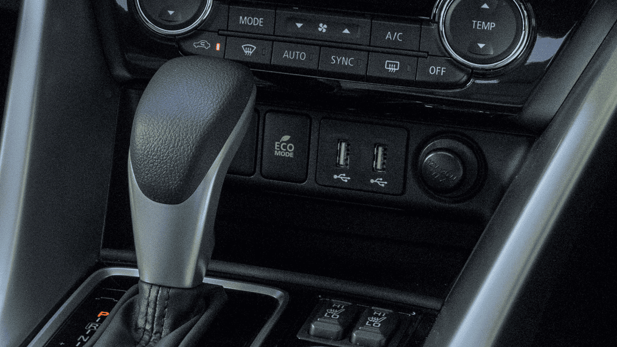 Detail view of the gear shifter and ECO mode USB port area inside the 2025 Mitsubishi Eclipse Cross, photographed near Tampa, FL to emphasize functional layout.