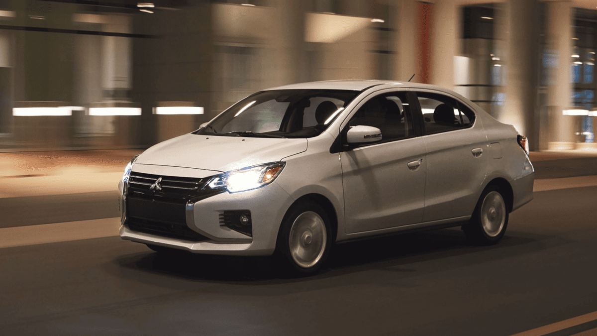 Front-side view of the 2024 Mitsubishi Mirage G4 in motion near Tampa, FL, showing off its aerodynamic sedan profile and LED headlights during a night drive.