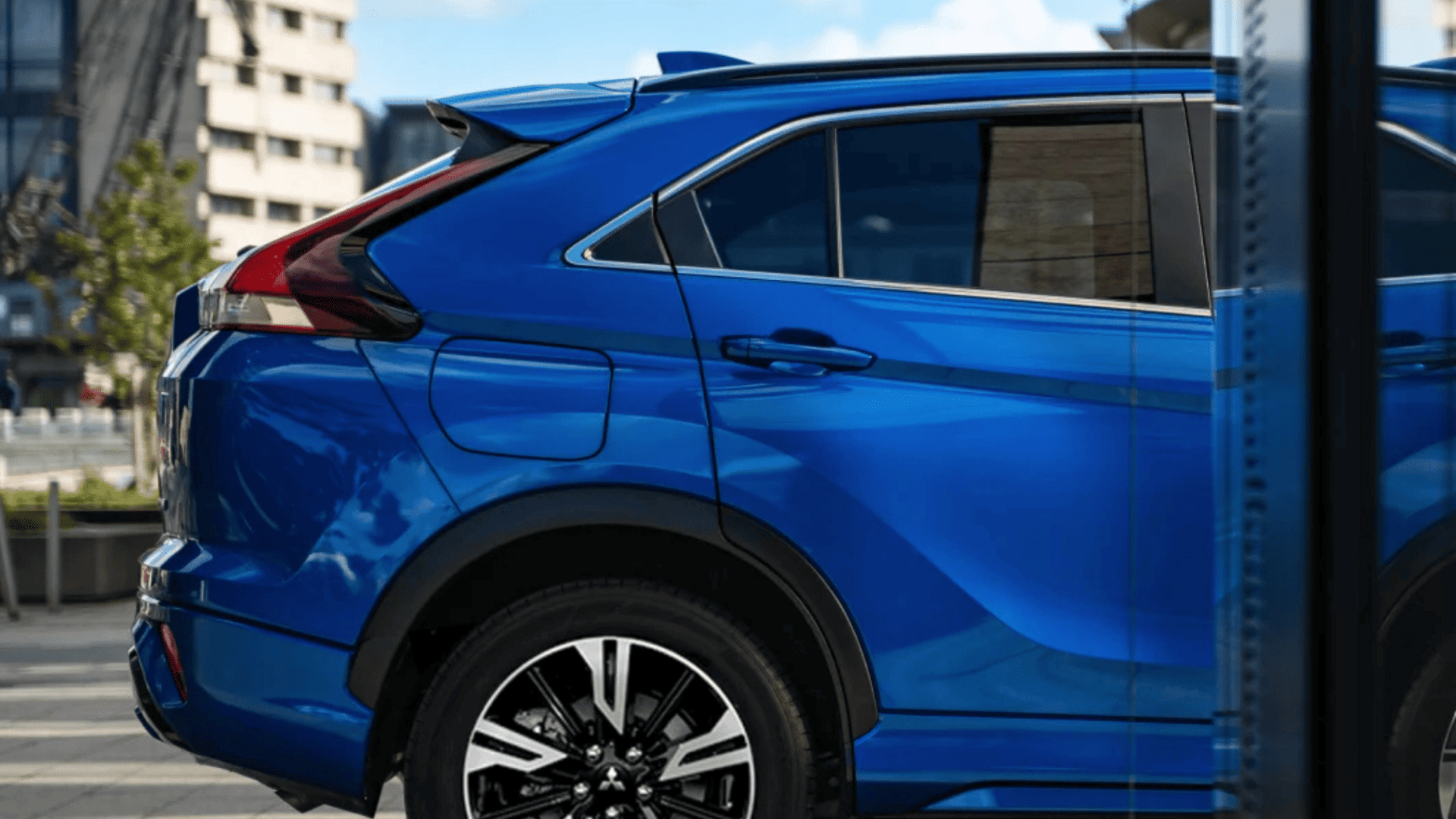 Side rear view of 2025 Mitsubishi Eclipse Cross in blue parked in urban Brandon, FL