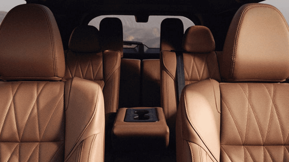 Interior view of the 2025 Mitsubishi Outlander’s three-row seating in tan leather near Tampa, FL, highlighting spaciousness, upscale stitching, and premium comfort.