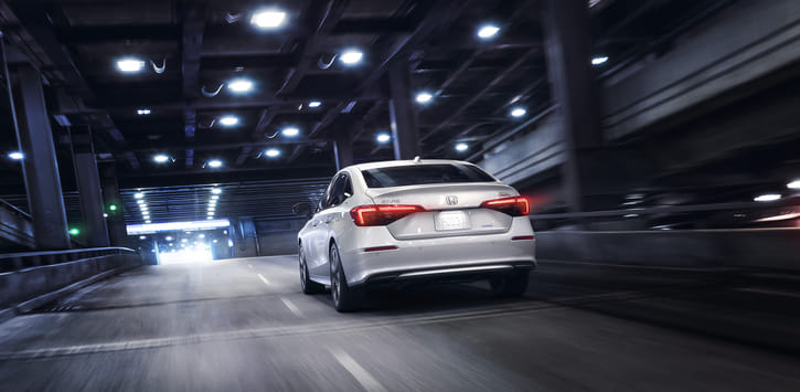 White Honda Civic Driving through the city at night