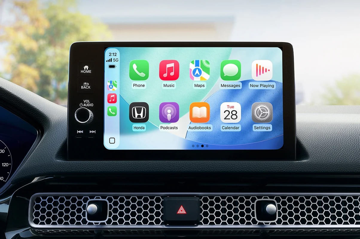 2026 Honda Civic Sedan dashboard display showing Apple CarPlay interface with apps for Phone, Music, Maps, and more, conveying a high-tech, user-friendly vibe.