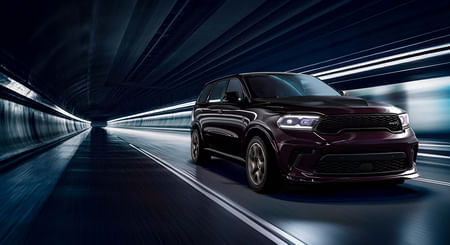 A black 2025 Dodge Durango driving through a lighted tunnel.