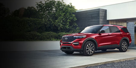 A red Ford Explorer parked in the driveway.